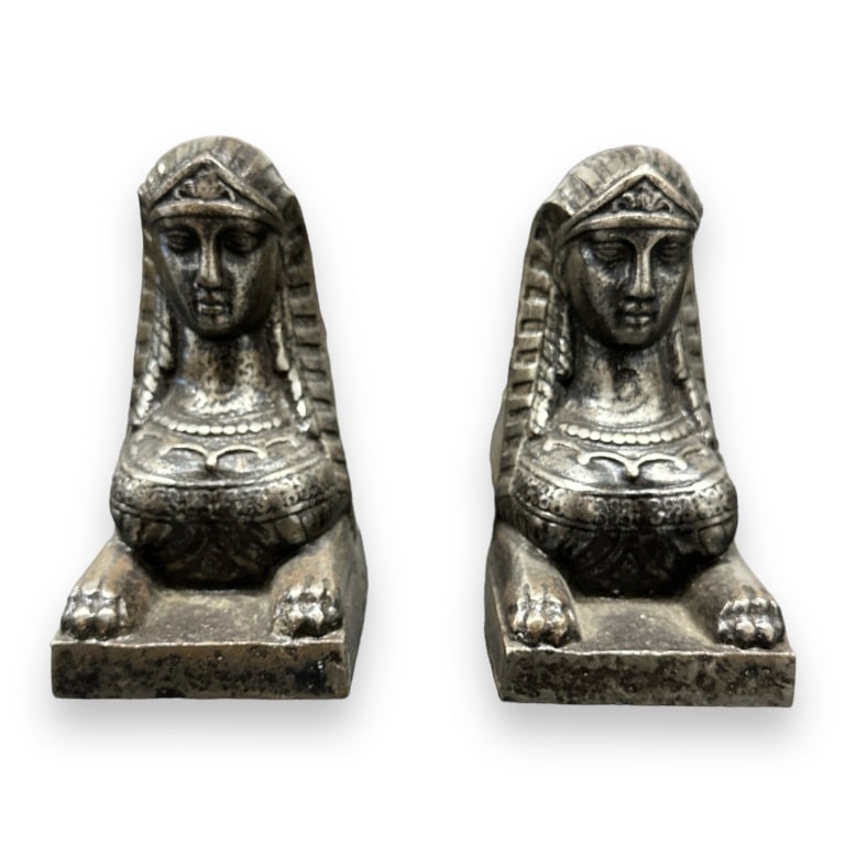 A pair fo vintage silvered iron Egyptian Revivial fireplace andirons having a figural Sphinx design. (1 of 2)