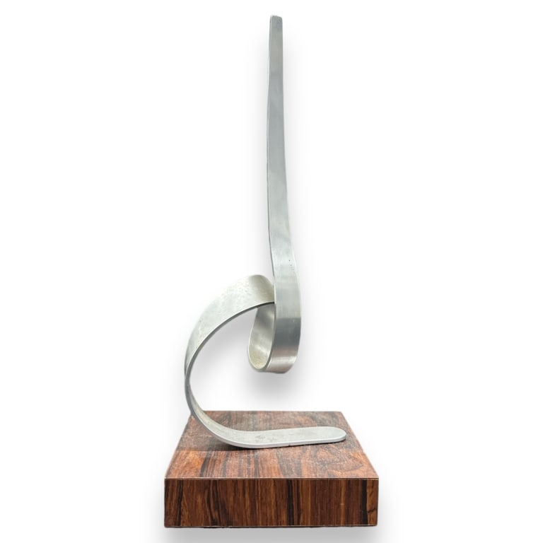 Charles Taylor aluminum kinetic work on wooden base. Signed. Measures approx. 13 1/2" height overall: Charles Taylor aluminum kinetic work on wooden base. Signed. Measures approx. 13 1/2" height overall including base. Appears in overall good condition. JD/B17