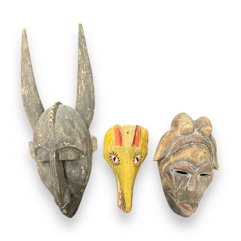 A lot of four vintage, possibly antique, African wooden masks and wall art sculptures. One with (1 of 3)