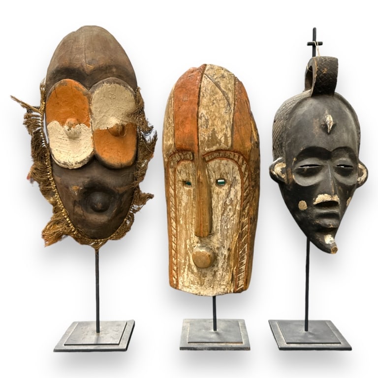 A lot of three vintage African hand carved wooden masks with display stands. Tallest measures (1 of 4)