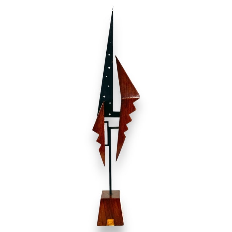 A vintage Danodella Italy wood and metal modernist sculpture. Retains labels to front and back.: A vintage Danodella Italy wood and metal modernist sculpture. Retains labels to front and back. Measures approx. 28" height x 6 1/2" width x 3 1/2" depth. Fading to labels. Otherwise, appears in overa