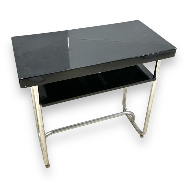 A vintage black lacquer top and aluminum? metal frame table with secondary shelf. No apprent labels (1 of 3)