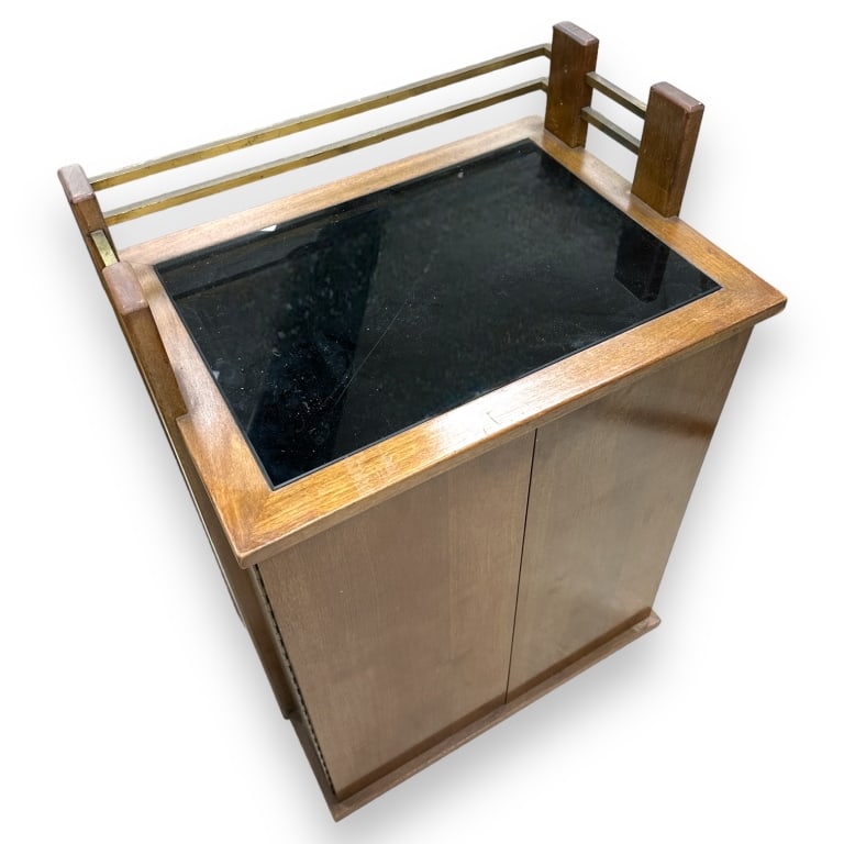 A vintage mid century modernist cabinet crafted of wood with brass. Measures approx. 39" height x: A vintage mid century modernist cabinet crafted of wood with brass. Measures approx. 39" height x 27" width x 20" depth. Appears in overall good condition. JD/B13