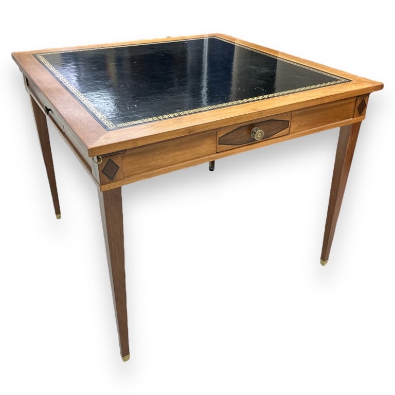 A vintage black leather top wooden game table with gold Greek key meander design. Has drawers to (1 of 3)