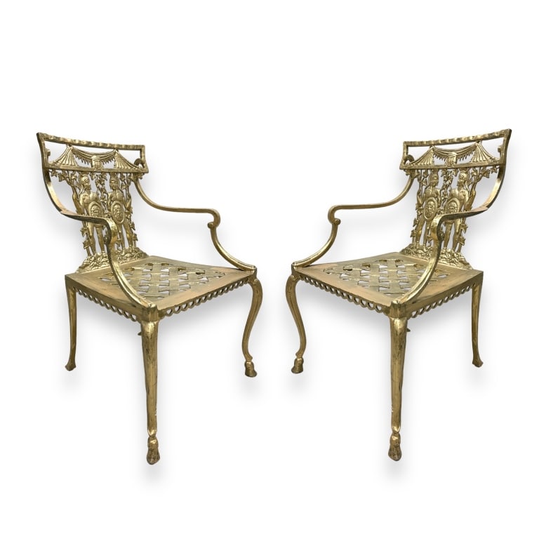A pair of mid century Romanesque ornate gilt metal garden arm chairs. Measures approx. 33" height x: A pair of mid century Romanesque ornate gilt metal garden arm chairs. Measures approx. 33" height x 23" width x 21" depth. Appear in overall good condition for age. JD/B13