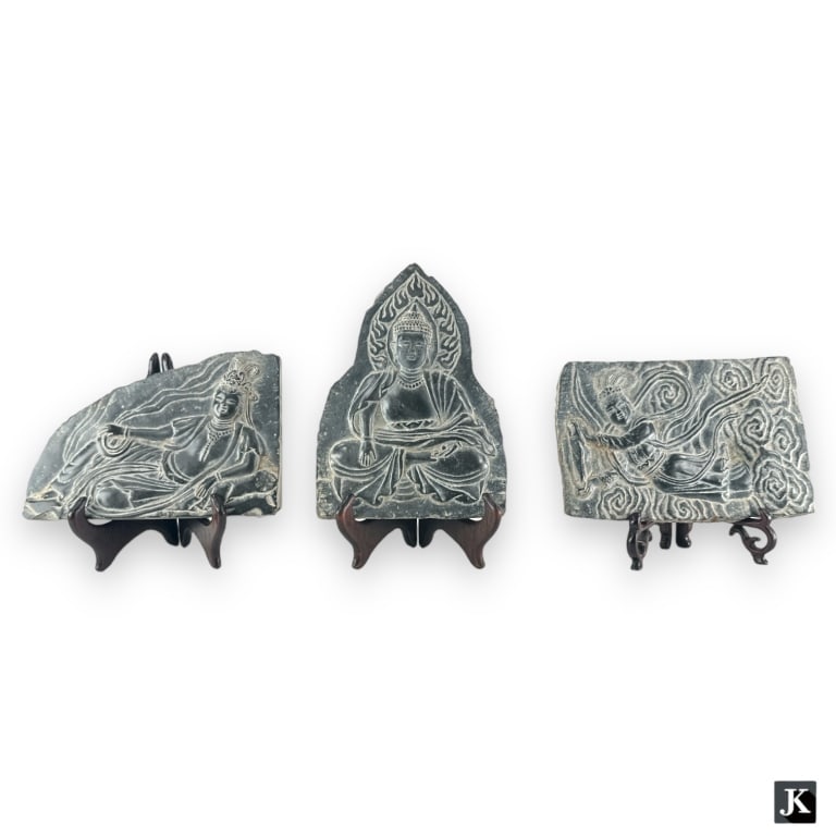 A lot of three Chinese black hard stone plaques depicting Budhha and Guan Yin. Each accompanied with (1 of 4)