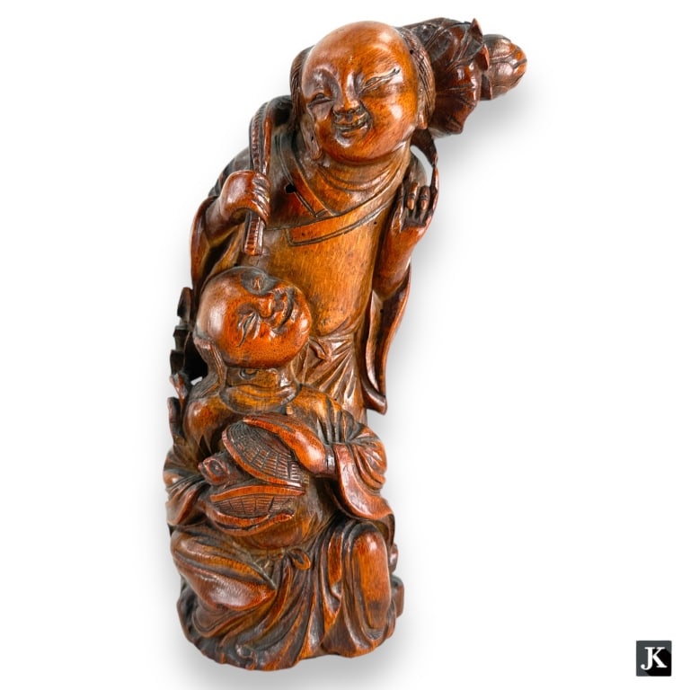 Chinese carved bamboo wood groups sculpture depicting two men; one holding a lotus and the other: Chinese carved bamboo wood groups sculpture depicting two men; one holding a lotus and the other holding baskets with frog. No apparent hallmarks. Measures approx. 9 5/8" height. Has break or chip to 
