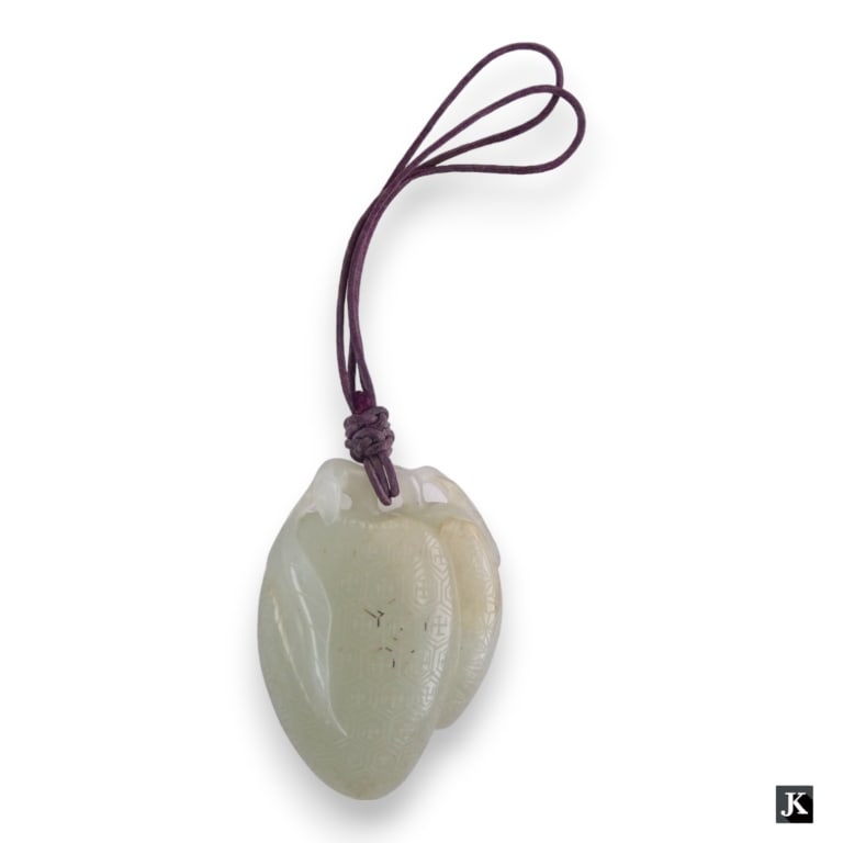 A finely carved Chinese white Hetian jade toggle pendant having a figural peach design. Has (1 of 3)