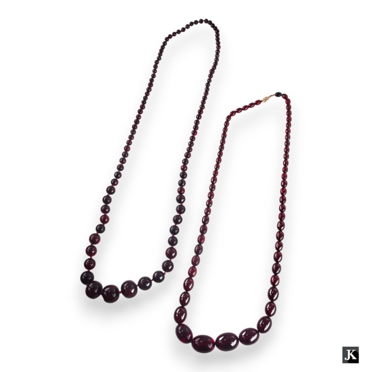 A lot of two Chinese cherry amber graduating beaded necklaces. One hand knotted inbetween each bead (1 of 4)