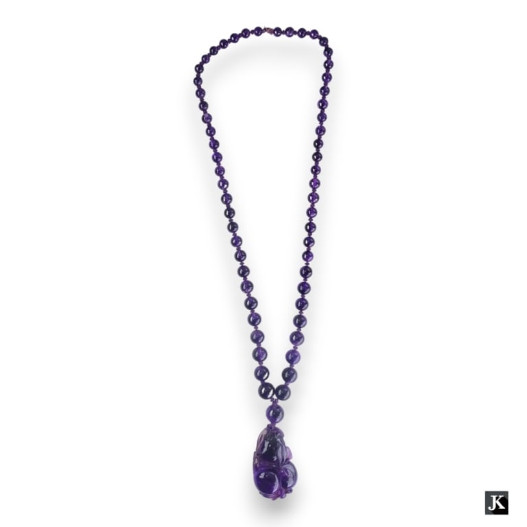 A Chinese carved amethyst quartz figural peaches pendant set on graduating amethyst beaded necklace. (1 of 4)