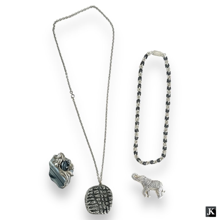 A lot of 4 vintage sterling silver and silver tone jewelry items. Lot is to include a two sone (1 of 4)