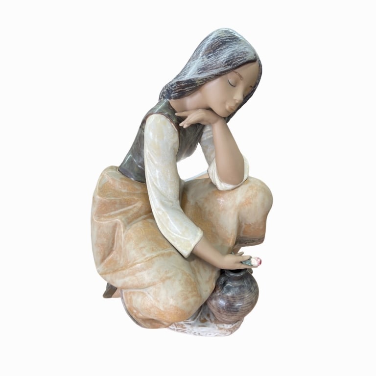 A Lladro Spanish stoneware sculpture depicting a seated young woman with flower and water vase (1 of 4)