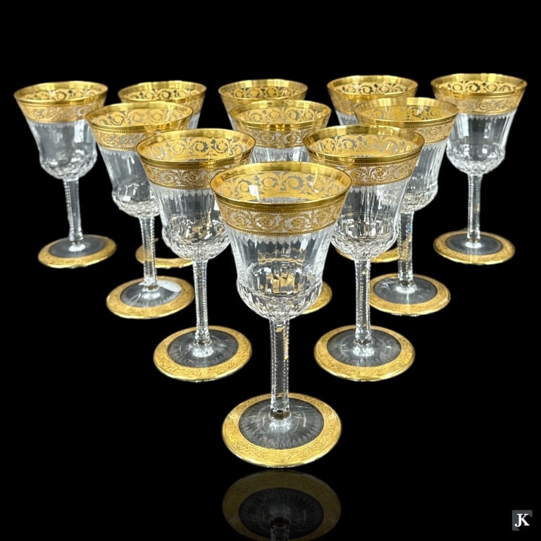 A set of 11 Saint Louis Crystal France burgundy wine stemware glasses in the "Thistle" pattern: A set of 11 Saint Louis Crystal France burgundy wine stemware glasses in the "Thistle" pattern having a gold gilt encrusted scrolled design. Round hallmarks to bottoms. Each measures approx. 6 3/8" he