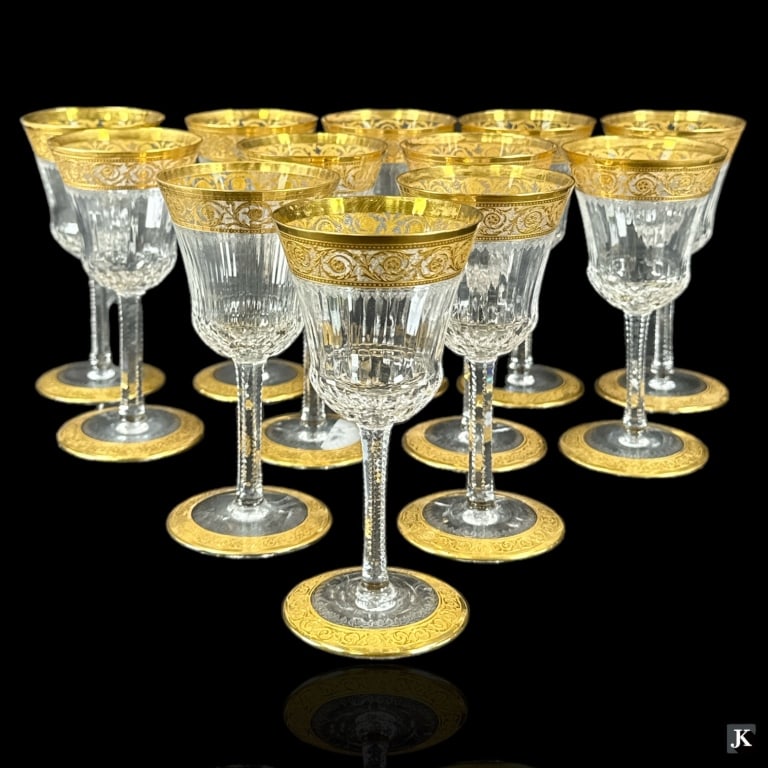 A set of 12 Saint Louis Crystal France claret wine stemware glasses in the "Thistle" pattern having: A set of 12 Saint Louis Crystal France claret wine stemware glasses in the "Thistle" pattern having a gold gilt encrusted scrolled design. Round hallmarks to bottoms. Each measures approx. 5 5/8" heig