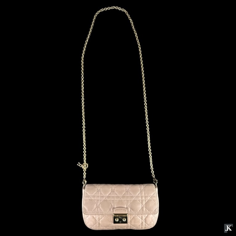 A designer Christian Dior pink leather crossbody bag with gold tone hardware. Measures approx. 5 (1 of 3)