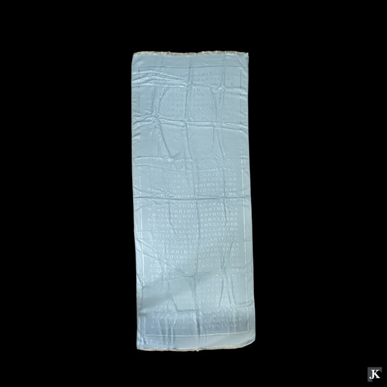 Designer Bulgari / Bvlgari Italy sky blue fabric shawl scarved with stitched designer name design.: Designer Bulgari / Bvlgari Italy sky blue fabric shawl scarved with stitched designer name design. Comprised of 65% silk and 35% wool. Measures approx. 69" length x 28 1/2" width. Appears in overall g