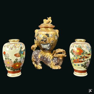 A vintage Satsuma Japanese hand painted porcelain cabinet garniture to include a foo lion covered: A vintage Satsuma Japanese hand painted porcelain cabinet garniture to include a foo lion covered vase and two landscape vases. All pieces signed to bottoms. Foo lion vase measures approx. 6" height.