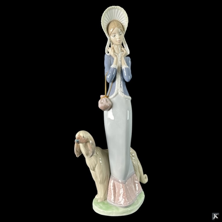 Lladro Spain "Stepping Out" Porcelain Figure #1537: Lladro Spanish glazed porcelain sculpture titled "Stepping Out" or "De Paseo Con El Perro" number 1537. Sculpted by Juan Huerta. Issued in 1988 and retired in 2000. Measures approx. 13 1/2" height. In