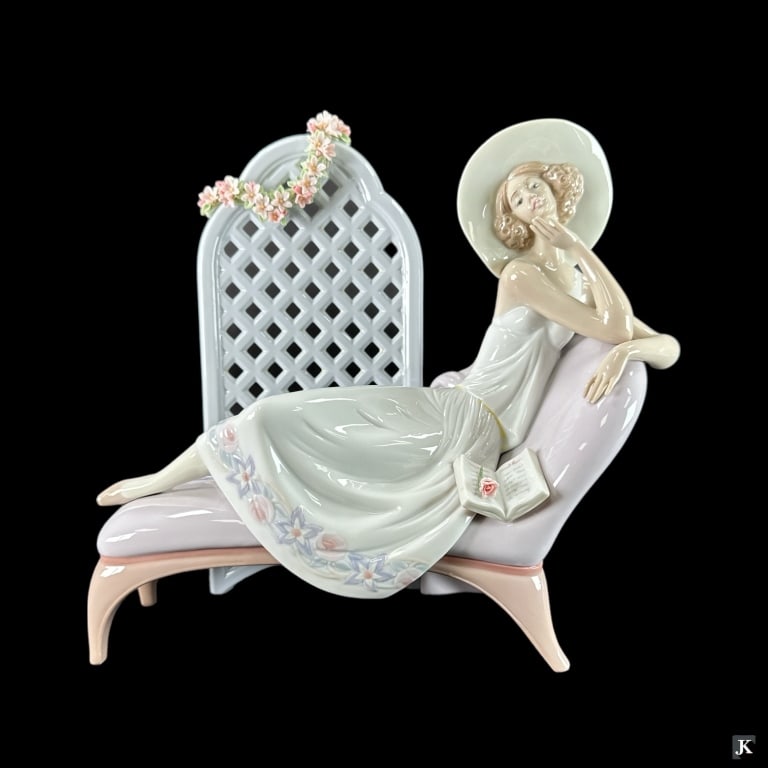 Lladro Spain "Garden Dreams" Porcelain Figure 7634: Lladro Spanish glazed porcelain sculpture titled "Garden Dreams" or "POEMAS DE AMOR S.L." number 7634. Sculpted by José Puche. Issued in 1994 and retired in 1996. Measures approx. 12 1/2" height. Inc