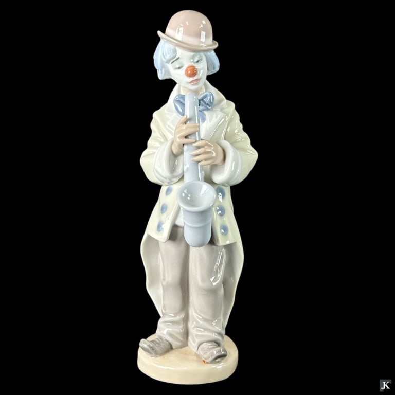 Lladro Spain "Sad Sax" Porcelain Figure #5471: Lladro Spanish glazed porcelain sculpture titled "Sad Sax" or "Payasito Saxofon" number 5471. Sculpted by Francisco Catalá. Issued in 1988 and retired 2018. Measures approx. 8 3/4" height. Includes b
