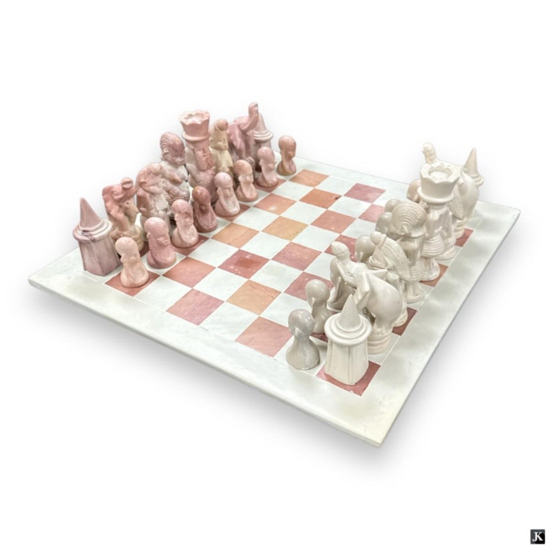 African Tribal Motif Carved Stone Chess Set: Carved stone chess set having an African Tribal design. Includes stone board. Shortest piece measures approx. 2 3/8" height and tallest measures approx. 5 1/4" height. Board measures approx. 1/4" heig