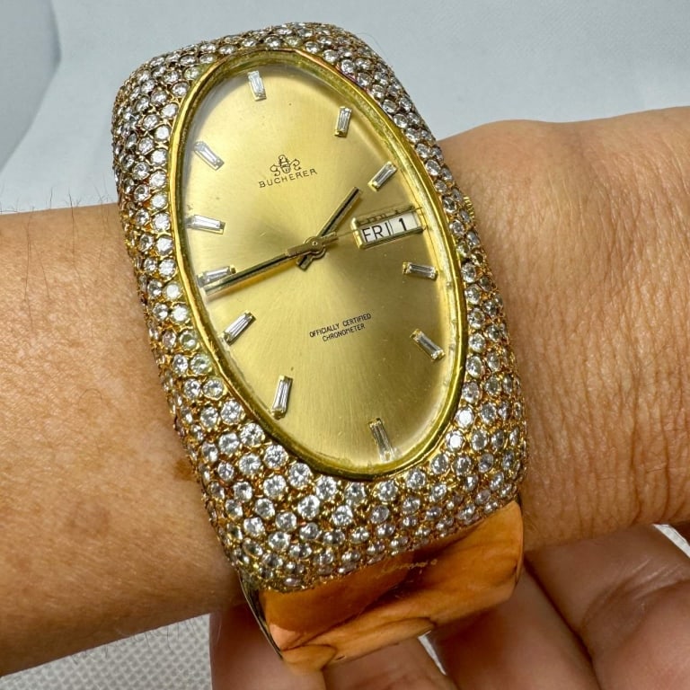 Women's BUCHERER 18K Yellow Gold Watch: BUCHERER 18K Yellow Gold Watch Weighing 125.4 grams Set with app. 500 Diamonds weighing app. 25.00 Ct.G-H Color, VS1-SI1 Clarity 59 x 35mm Automatic movement. 10814