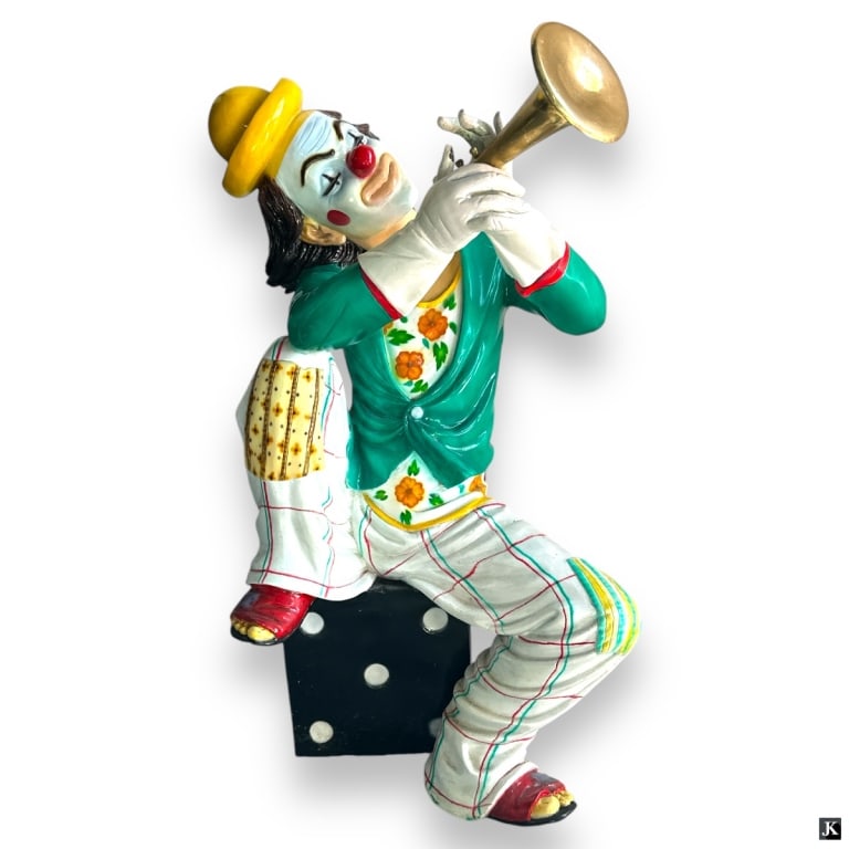 Cold Painted Metal Large Clown With Horn Sculpture: A cold painted large metal bronze sculpture depicting a clown with a horn seated on a black dice. No apparent signature. Measures approx. 31" height. Horn will need to be re-bonded to hands. Otherwise