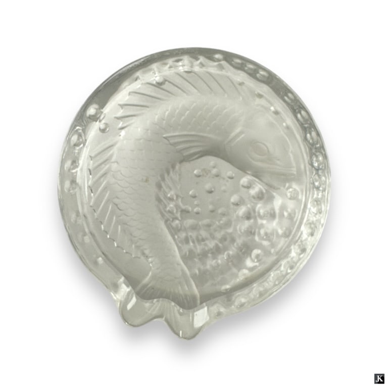 Lalique France Crystal Concareau Fish Ashtray Bowl: A Lalique French cut crystal "Concareau" ashtray bowl having a fish design. Etched signature to side. Measures approx. 2" height x 6" diameter. Some shelf scratching to bottom. Otherwise, appears in o