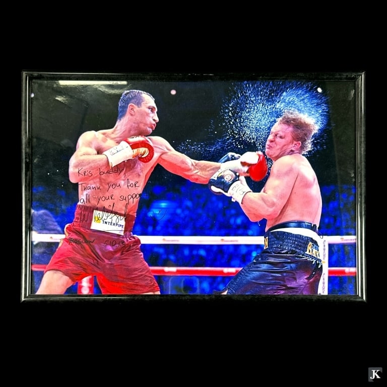 Signed Wladimir Klitschko Fight Photograph Framed: A signed Wladimir Klitschko boxing action fight photograph signed by the box with dedication. Mounted in a black metal frame behind acyrlic screen. Measures approx. 12 1/2" height x 18 1/4" width over