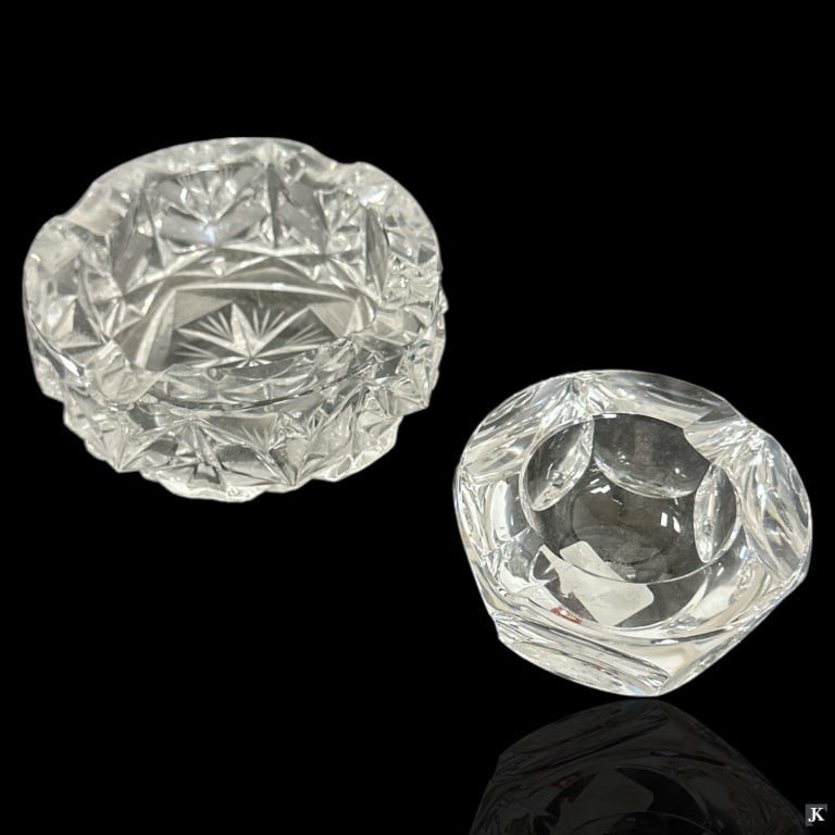 2 Cut Glass Ashtrays Baccarat American Brilliant: A lot of 2 vintage and antique ashtrays crafted of cut glass / crystal. One by Baccarat and another appears to be American Brilliant cut with no apparent hallmarks. Largest measures approx. 2 1/8" hei
