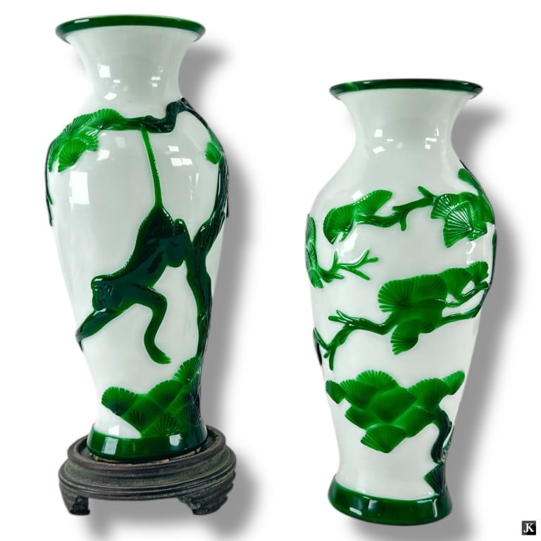 Pair Vintage Chinese Peking Glass Vases: Pair Vintage Chinese Peking Glass Vases. An overlay of green glass featuring swinging Monkey motif. Unsigned. Good condition. One vase with wood base adhered to bottom, the other with no base. Glass v