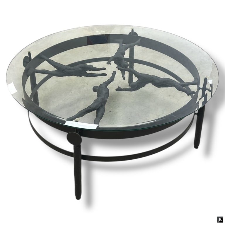 Contemporary Bronze & Glass Figural Coffee Table: Contemporary Bronze & Glass Figural Coffee Table. Featuring 4 nude figural base with a beveled glass top. Unsigned. Good condition. Measures 19-1/2" H x 46-1/4" diameter. LA/B17