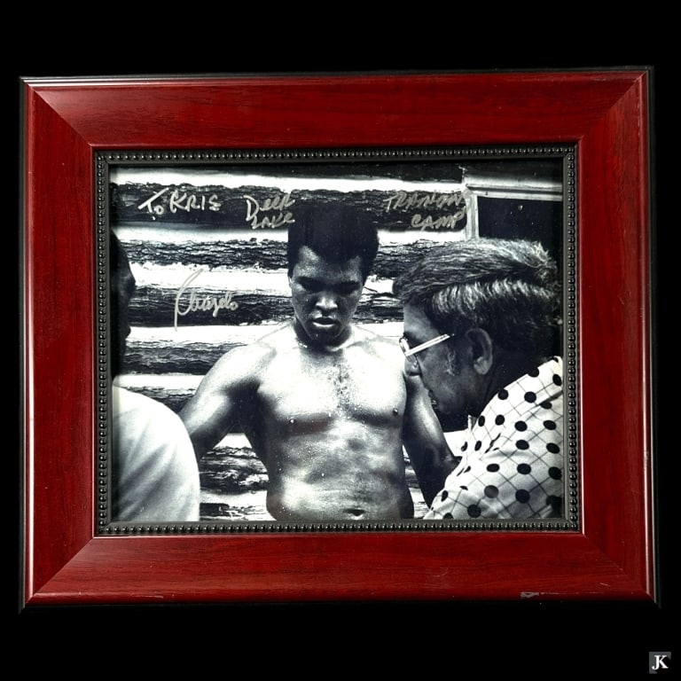 Signed Angelo Dundee Deer Lake Training Photo: A signed Angelo Dundee photograph depicting Muhammed Ali at Deer Lake training camp. Mounted in a wooden frame with glass screen. Measures approx. 11 1/4" height x 13 1/4" width overall including fram
