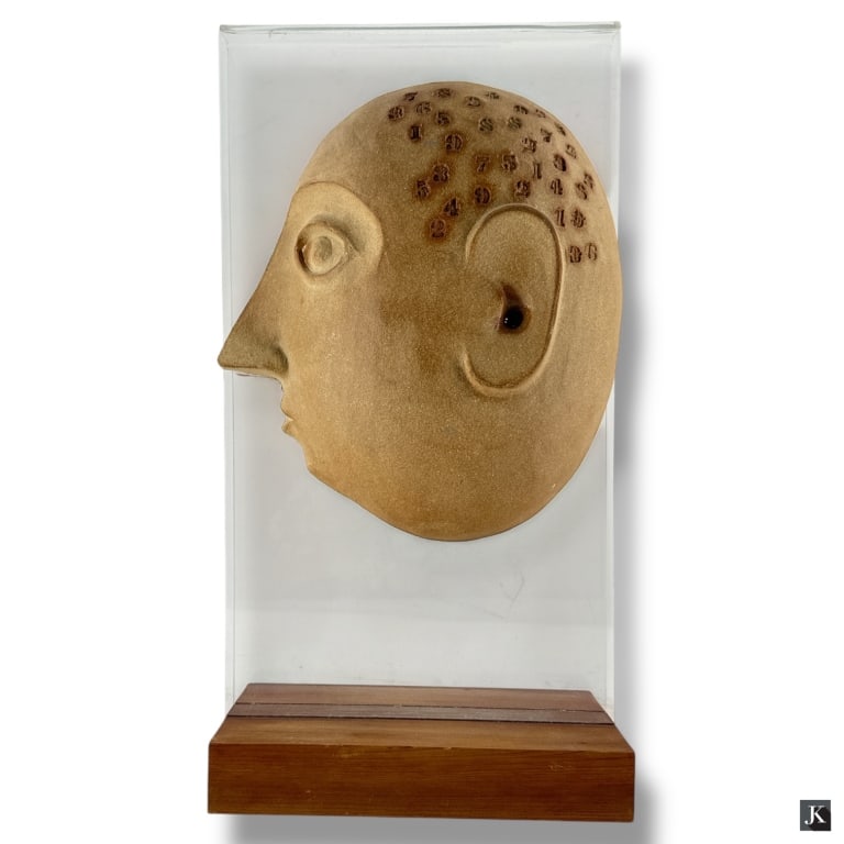 David Gil Art Pottery "Split Head with Numbers": David Gil, American (1922-2002) for Bennington Potters art pottery sculpture "Split head with Numbers" mounted to lucite on wooden base. Impressed markings. Good condition. Measures 19" H x 10" W x 5-