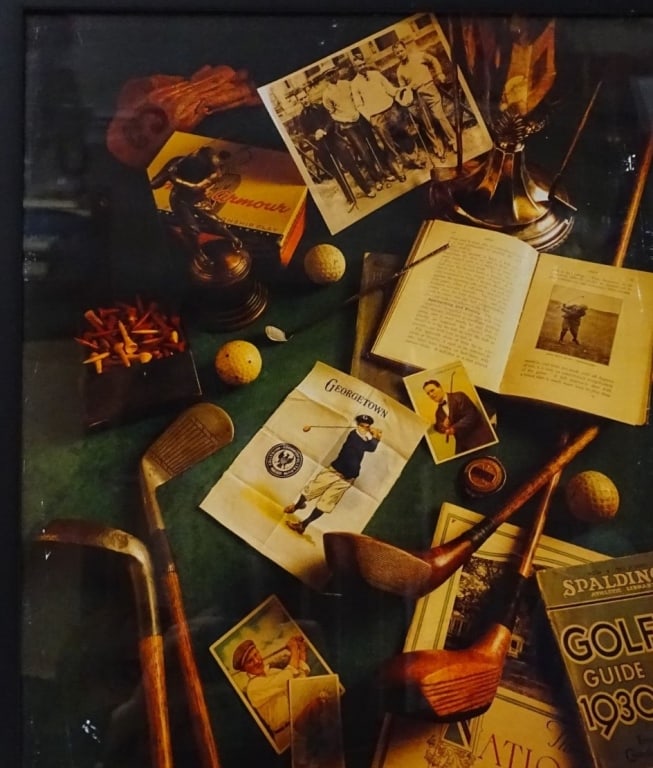 Framed Color Print "Golf Table": Framed color print depicting a table covered in golf paraphernalia and media. Some wear on frame, print and acrylic is separated on upper right from frame, otherwise in good condition. Measures(sight)