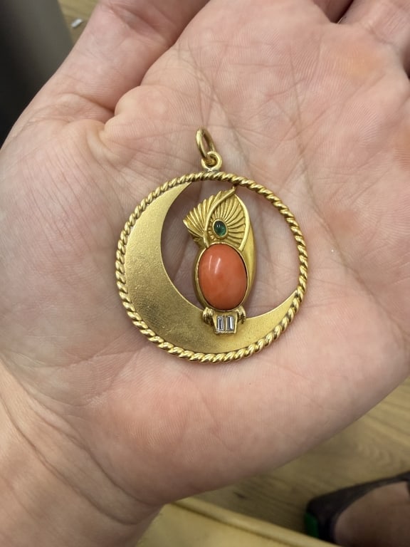 A Cartier Diamond, Coral & Emerald Owl Pendant: A Cartier Diamond, Coral & Emerald Owl Pendant. Stamped 18K. Numbered 6920. 18 Karat Yellow Gold. Features an Owl Perch on a Half Moon. Total Weight 13.36 DWT. Measures 2 inches diameter.