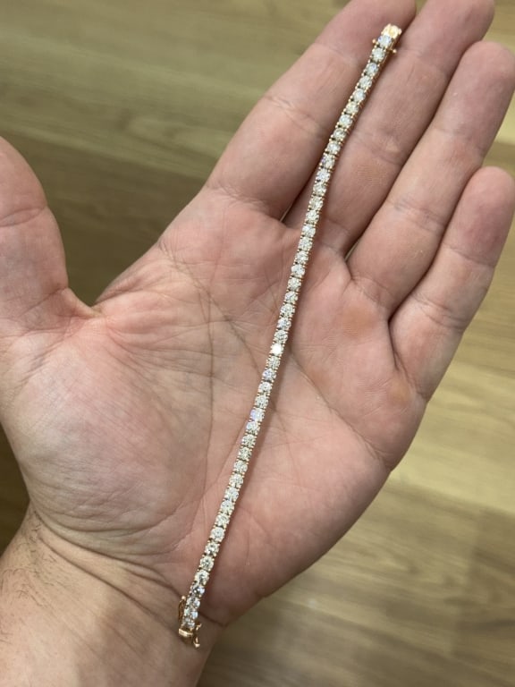 9ct Diamond Tennis Bracelet Set In 14 Karat: 9ct Diamond Tennis Bracelet Set In 14 Karat Rose gold. 45 round Brilliant cut diamonds. approx 0.20 Each. Vs-SI Clarity. K Color. Measures 7 1/4 inches.
