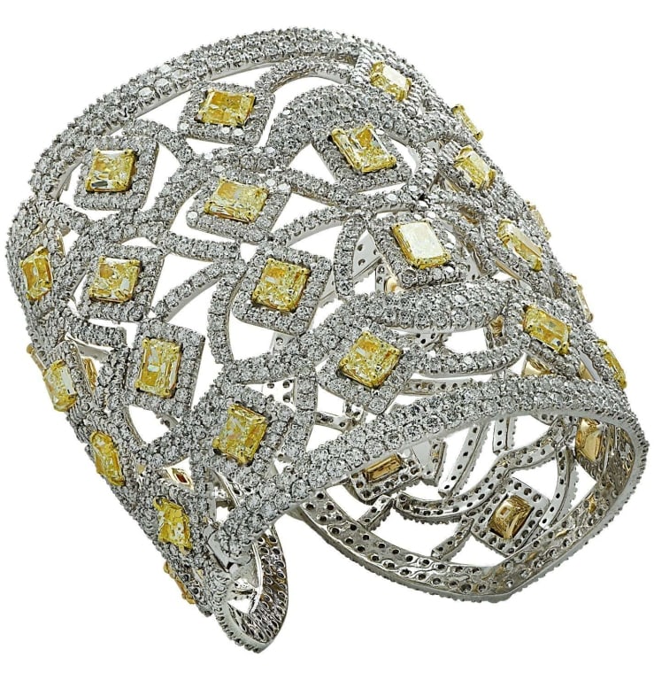 72.44 Carat Fancy Yellow Diamond Cuff Bangle in 18: Spectacular Diamond cuff bangle crafted in 18 karat white and yellow gold, showcasing fancy yellow radiant cut and round brilliant cut diamonds weighing approximately 72.44 carats total. 32 Light yell