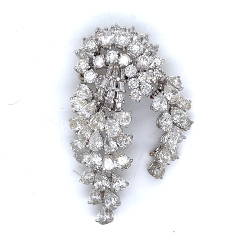 1950’s Platinum 22.00 Ct Diamond Brooch: Item # 13065 Category Pins - Clips 1950’s Platinum 22.00 Ct Diamond Brooch Weighing 35.3 grams Set with 34 Pear-shaped Diamonds weighing app. 13.00 Ct. Along with 12 Baguette Diamonds weighing app.