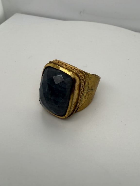 Vintage Gold Colored Gemstone Ring: Vintage gold colored blue gemstone ring. Stamped 'JV' on inside. Some wear and minor tarnishing present, otherwise in good condition. Size 9