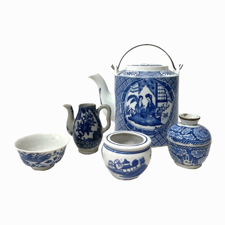 Chinese Porcelain Tea Set: Set of blue and white Chinese porcelain, includes five pieces: teapot with lid, teacup, cream jug, one sugar bowl with lid, one sugar bowl without lid. Teapot depicts a traditional Chinese tea