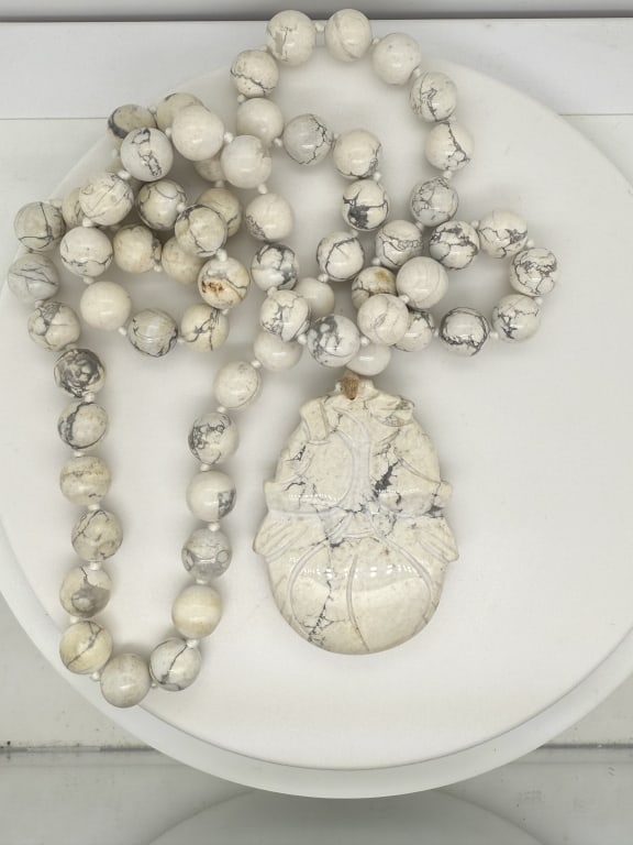 Vintage Chinese Howlite Carved Beaded Necklace: Vintage Chinese howlite carved beaded necklace with persimmon fruit pendant. No make or markings. Minor blemishing on pendant and bottom of the necklace, otherwise in good condition.