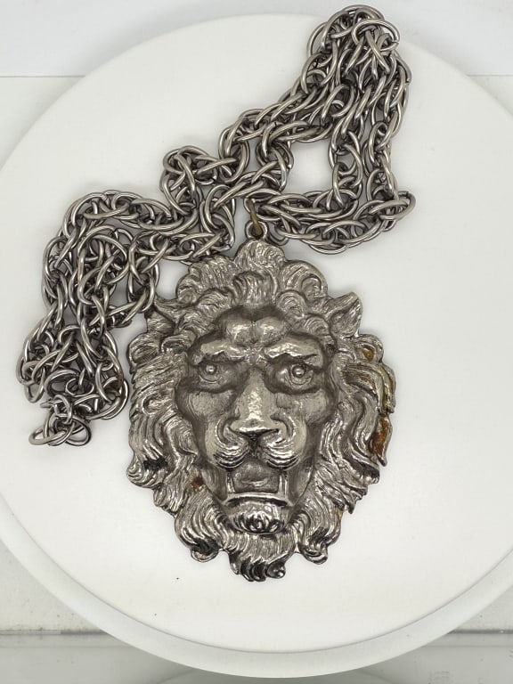 Vintage Large Lion Head Pendant With Necklace: Vintage Silver toned large lion head pendant with matching necklace. No make or marks. Minor blemishing on lwoer right of lion head and signs of age/use, otherwise in good condition.