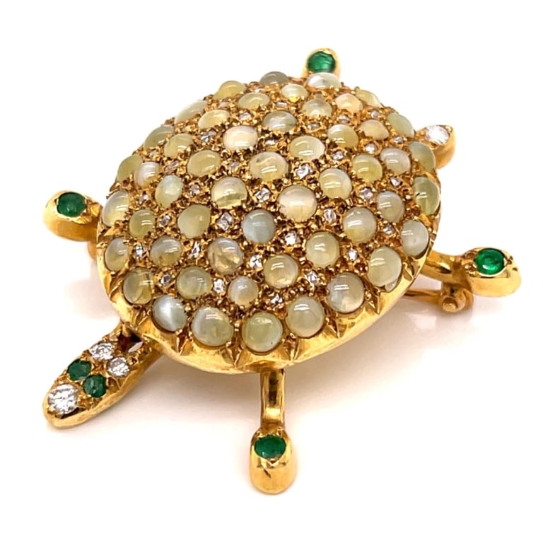 1960 18K Yellow Diamond, Emerald,Turtle Brooch: Item # 13658 1960’s 18K Yellow Gold Diamond, Emerald, and Cat’s Eye Turtle Brooch Weighing 16.3 grams Set with app. 1.00 Ct. of Diamonds F-I Color, VS1-SI2 Clarity Along with app. 4.00 Ct. of