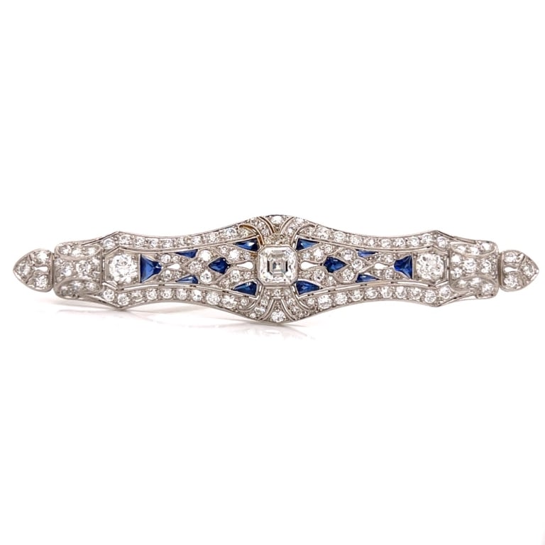 Art Deco Platinum Diamond & Synthetic Sapphire Bro: Item # 13598 Category Pins - Clips Art Deco Platinum Diamond & Synthetic Sapphire Brooch Weighing 13.0 grams Set with an app. 1.00 Ct. Ascher-cut Diamond in center Along with 118 Diamonds weighing