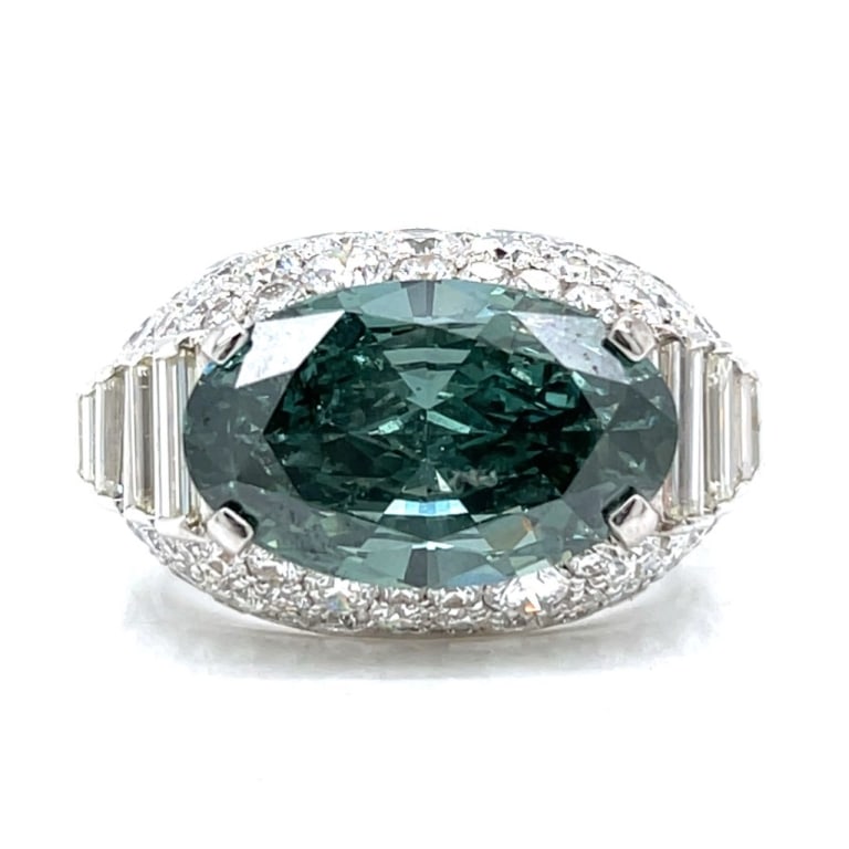 GIA Certified 7.09 Ct. Fancy Diamond Ring: Item # 12721 18K White Gold GIA Certified 7.09 Ct. Fancy Deep Grayish Green Diamond Ring Weighing 10.7 grams Set with a GIA Certified 7.09 Ct. Oval Diamond Fancy Deep Grayish Green Color (Treated) I2