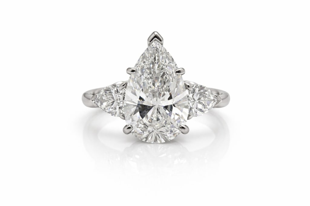 Ladies GIA certified diamond engagement ring: Ladies GIA certified diamond engagement ring Set with two .75 carat GIA certified diamonds GIA certified 5.08ct Pear Shape SI1-I