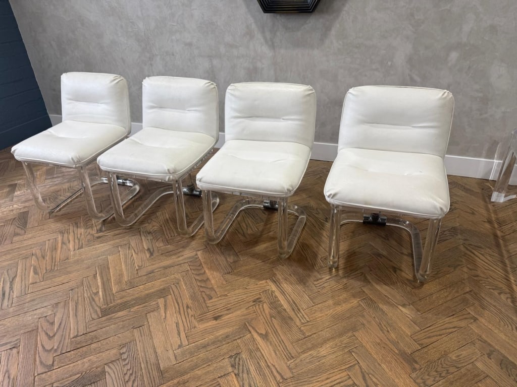 Set of 4 signed lion in frost lucite dining chairs: Set of 4 signed lion in frost lucite / chrome and vinyl swivel dining chairs Dimensions: Seat height 17" PICK UP LOCATION - WEST LA, LOS ANGELES