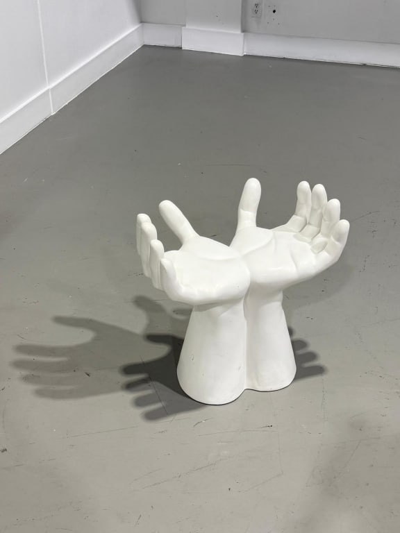 A Ceramic Open Hand Chair: A Ceramic Open Hand Chair Measures: 24 inches high by 24 inches wide