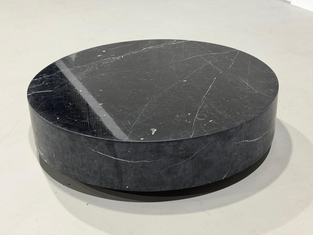 A Stunning Black Marble Coffee Table: A Stunning Black Marble Coffee Table Measures: 14 1/2 inches high by 55 inches diameter on wheelsPICK UP LOCATION 32 S Dixie Hwy, Lake Worth, FL 33460